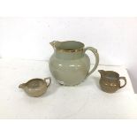 A group of three ceramic jugs, one possibly inscribed Wedgwood to base, all with gilt decoration (