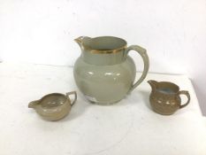 A group of three ceramic jugs, one possibly inscribed Wedgwood to base, all with gilt decoration (