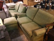 A pair of modern two seater sofas upholstered in cream pattern fabric, with green damask loose