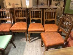 A set of five Edwardian spar back dining chairs with stuffover seats in vinyl raised on turned