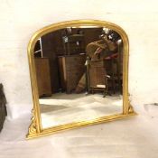 A modern gilt framed overmantel with acanthus leaf scroll base and fluted arched moulded frame (