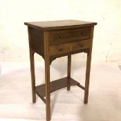 An Edwardian mahogany side table, with hinged top enclosing a fitted interior, the rectangular top