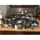 A collection of pewter including candlesticks, tankards, measures, jugs (candlestick: 21cm), some