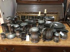 A collection of pewter including candlesticks, tankards, measures, jugs (candlestick: 21cm), some