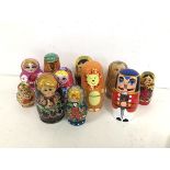 A collection of Russian nesting dolls, most with traditional female faces, others with animal