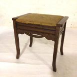 An Edwardian walnut box top piano stool with tapestry top, raised on square splay supports (48cm x