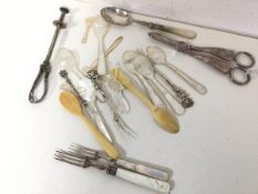 An assortment of bone and mother of pearl spoons, Epns grape scissors, a fork with silver collar and