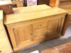 A John Lewis style oak sideboard, the rectangular top with rounded angles and moulded edge above a