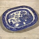 A 19thc English china meat ashet, decorated with transfer printed Three Men on a Bridge pattern (