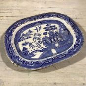 A 19thc English china meat ashet, decorated with transfer printed Three Men on a Bridge pattern (