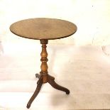 A 19thc mahogany pedestal wine table, the circular top on baluster turned column and tripod support