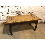 A modern coffee table with parquetry top above a moulded apron, on cabriole legs, inscribed W.