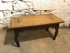 A modern coffee table with parquetry top above a moulded apron, on cabriole legs, inscribed W.