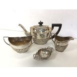 A matched silver batchelor's tea service including teapot, milk jug and sugar bowl, all with half