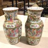 A pair of 19thc Chinese baluster vases with fluted rims, decorated with scrolling dragons and scenes