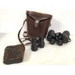 A pair of Swift Newport model no. 825 binoculars (18cm x 19cm x 6cm), complete with leather