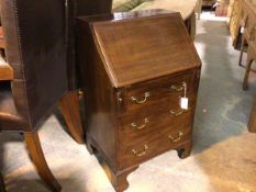 An Edwardian mahogany inlaid neat bureau, the rectangular inlaid top above a fall front enclosing