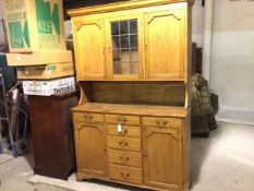 A 1920s oak two part dresser, the top with moulded cornice and centre glazed leaded glass panel door