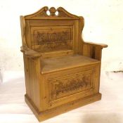 A reproduction pine miniature hall bench with broken swan neck pediment to top and relief carved