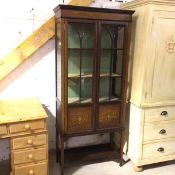 An Edwardian mahogany inlaid display cabinet, the frieze with harebell and ribbon design above a