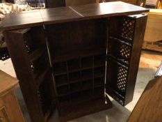 An Eastern hardwood fold out cocktail cabinet/mini bar, the rectangular top with hinged fold over