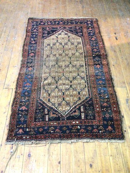 A North West Persian rug, with large diamond medallion and multiple flowerheads, within multiple