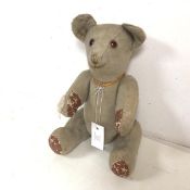 A vintage teddy bear, with moveable arms and legs, well worn (43cm)