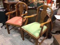 A pair of figured walnut 1920s carver chairs with pierced splat backs and scroll arms, with slip