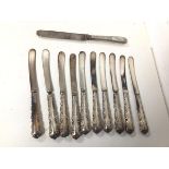 A set of ten Sheffield silver handled butter knives and a 1905 London silver knife with silver