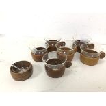 A set of six 1960s/70s German coffee cups, each with a wooden base and handle with glass insert,