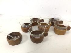 A set of six 1960s/70s German coffee cups, each with a wooden base and handle with glass insert,