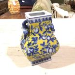 A modern Chinese baluster porcelain vase decorated with peach fruit and leaves, yellow ground (