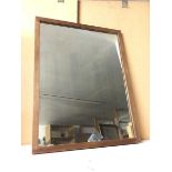 A wall mirror within a rectangular wooden frame (74cm x 57cm)