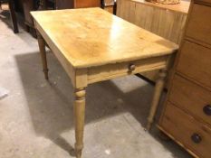 A 19thc stripped pine kitchen table, the rectangular top with moulded edge above a frieze drawer