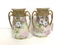 A pair of Noritake vases, of flattened bottle form with flared rim with handles to sides, on