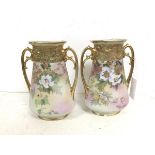 A pair of Noritake vases, of flattened bottle form with flared rim with handles to sides, on
