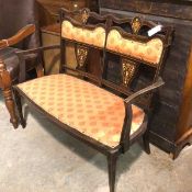 An Edwardian mahogany inlaid two seater drawing room settee with upholstered inset panel back and