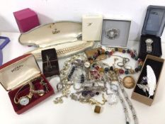A collection of costume jewellery including lady's wristwatches, brooches, necklaces, compacts,