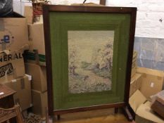 A 1930s walnut framed snap top firescreen/occasional table with sewn work panel, raised on shaped