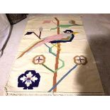 A flatwoven kelim style wall hanging with stylised bird on branch, cream field (182cm x 126cm)