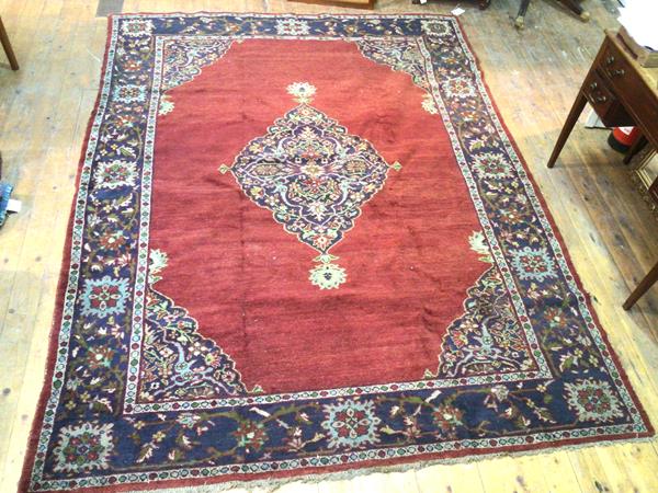 A 1920s North Persian rug, the centre diamond shaped medallion enclosed by lotus flower and leaf
