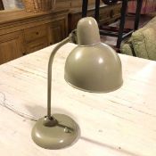 A Kaiser Idell original adjustable painted metal desk lamp with adjustable column, on circular