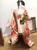 A traditional Japanese kimono with bamboo, crysanthemum and floral design, worked in gilt threads in