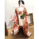 A traditional Japanese kimono with bamboo, crysanthemum and floral design, worked in gilt threads in