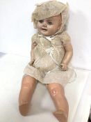 A vintage child's doll stamped A Reliable Doll, made in Canada with squeaker to back, torso and
