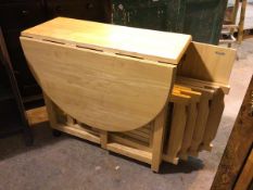 A John Lewis oak oval drop leaf gateleg dining table with panel doors to side, containing a set of