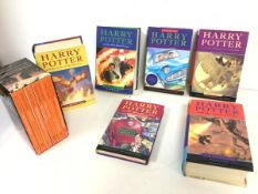 A set of six Harry Potter books, including The Philosopher's Stone and a boxed set of seven Roald