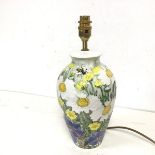 A Studio Pottery lamp of baluster form depicting flowers and a bee, inscribed to base Summer Meadows