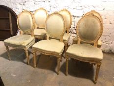 A set of six Louis XVI style side chairs all with distressed upholstered backs and seats, some