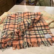 A Johnsons of Elgin lambswool blanket, with fringed border in orange, green and black check and